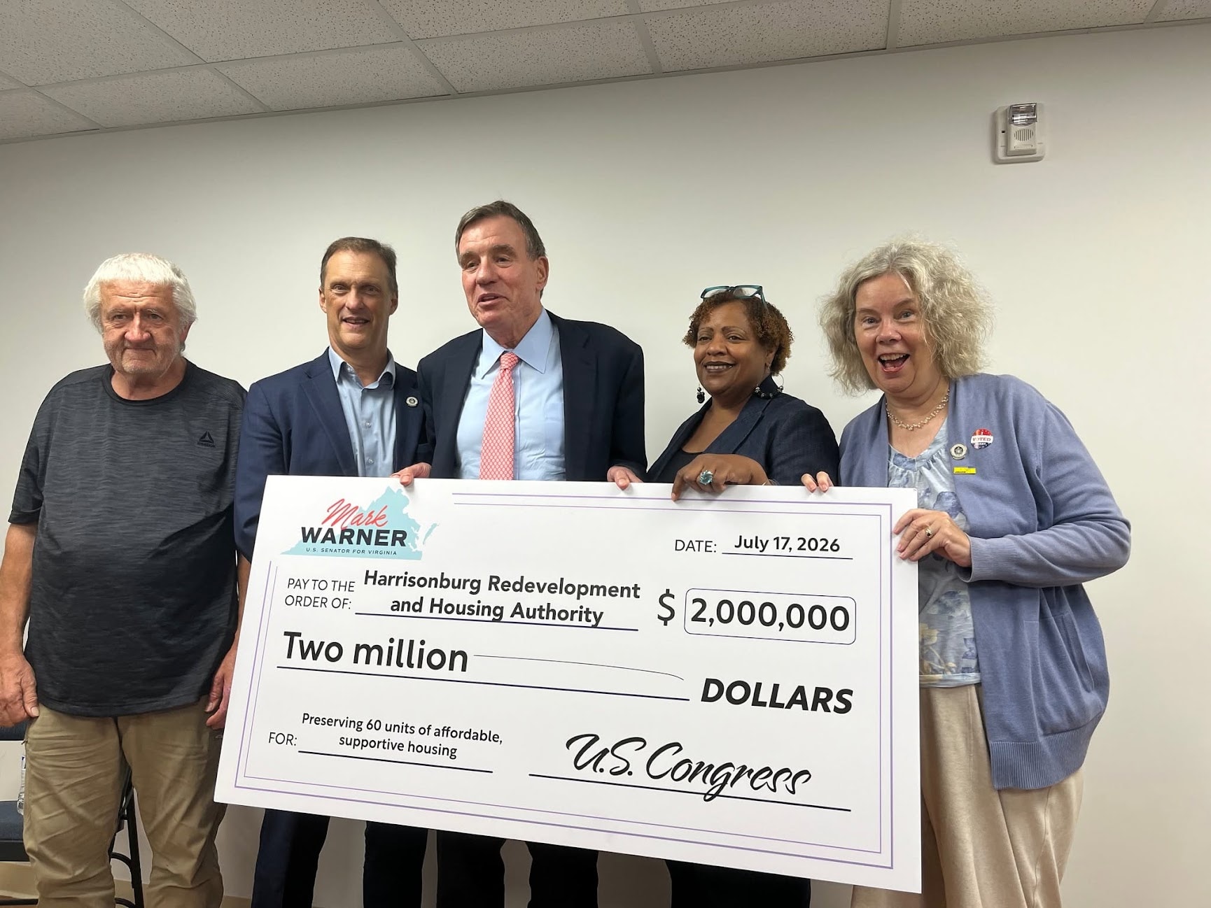 Community leaders presenting a ceremonial two-million-dollar check to the Harrisonburg Redevelopment and Housing Authority for preserving affordable supportive housing.